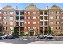 Attractive brick condominium building with private balconies and reserved parking spaces at 2300 Peachford Rd # 2404, Atlanta, GA 30338