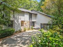 Two-story home featuring light siding, stone accents, dark trim, and an attached garage at 545 Matterhorn Way Way, Alpharetta, GA 30022
