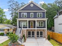 Stunning two-story home featuring a brick foundation and a striking dark gray facade at 2493 Oostanaula Ne Dr, Brookhaven, GA 30319