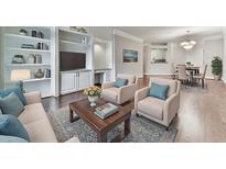 Bright living room with hardwood floors, built-in shelving, and comfortable seating area at 3334 Peachtree Ne Rd # 614, Atlanta, GA 30326
