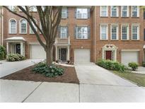 Charming townhome with brick facade, private garages, and welcoming curb appeal at 5147 Manerdale Se Dr # 5, Vinings, GA 30339