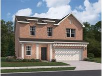 Charming two-story brick home with a manicured lawn and attached two-car garage at 337 Torcello Blvd, Mcdonough, GA 30253