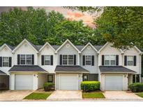 Charming townhouse featuring black shutters, single car garage and manicured lawn at 6947 Gallant Se Cir # 10, Mableton, GA 30126