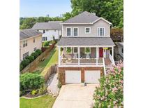 Charming two-story home featuring a front porch, two-car garage, and landscaped front yard at 218 South Se Ave, Atlanta, GA 30315