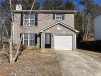 Two-story brick home with a single car garage and a neatly kept front lawn at 3116 Leyland Ct, Decatur, GA 30034