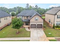 Inviting two-story home with a well-maintained lawn, two-car garage and stone-accented entryway at 212 Jetta Cir, Mcdonough, GA 30253