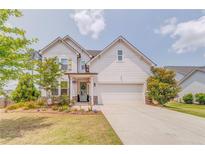 Charming two-story home featuring white siding, a two-car garage, and a beautifully landscaped front yard at 28 Rolling Rock Way, Dallas, GA 30157