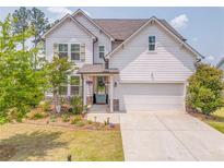 Charming two-story home with white siding, a well-manicured lawn, and a welcoming front entrance at 28 Rolling Rock Way, Dallas, GA 30157