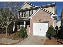 Charming two-story home with brick accents, attached garage, and well-manicured landscaping at 181 Ridgemont Rd, Canton, GA 30114