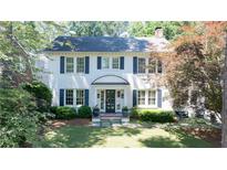 Charming two-story brick home featuring a new roof, classic blue shutters, and a welcoming entryway at 204 Rumson Ne Rd, Atlanta, GA 30305