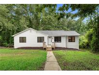 Charming renovated home featuring a landscaped yard and inviting front porch at 160 Pine Grove Dr, Canton, GA 30114