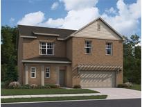 Charming brick two-story home featuring a two-car garage, manicured lawn, and traditional architectural details at 333 Torcello Blvd, Mcdonough, GA 30253
