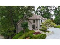 Charming home featuring manicured landscaping, mature trees, and a welcoming front entrance at 3616 Blakeford Ct, Marietta, GA 30062