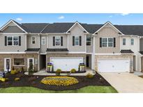 Charming townhomes feature brick accents, attached garages, and landscaped front yards in a desirable community at 1307 Aura Ln, Lawrenceville, GA 30045