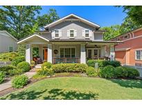Charming gray two-story home featuring a well-manicured lawn, lush landscaping, and inviting front porch at 629 2Nd Avenue, Decatur, GA 30030