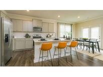 Modern kitchen features stainless steel appliances, a center island, and stylish seating at 3080 Yellowhammer Dr, Marietta, GA 30064
