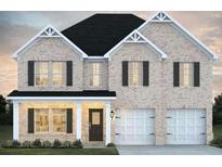 Charming two-story brick home featuring a two-car garage and inviting front porch with beautiful architectural detailing at 5370 Tolar Rd, South Fulton, GA 30213