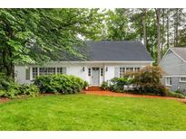 Charming single-story home boasts a lush front yard and a welcoming brick walkway leading to the front door at 956 Clifton Ne Rd, Atlanta, GA 30307