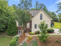 Charming two-story home featuring a lush landscaped front yard and inviting entryway at 5923 Rosie Se Ln, Mableton, GA 30126