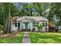 Charming renovated bungalow featuring a new roof, stylish green door, and a lush front yard at 2485 Hillside Ave, Decatur, GA 30032