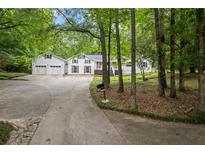 Charming two-story home with attached two-car garage and inviting curb appeal on a wooded lot at 3345 Bomar Rd, Douglasville, GA 30135