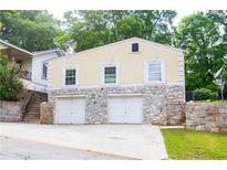 Two-story garage with stone base and neutral siding at 3349 Lavista Dr, Atlanta, GA 30354