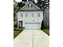 Charming two-story home featuring a two-car garage and manicured landscaping at 4450 Richmond Ct, Stone Mountain, GA 30083
