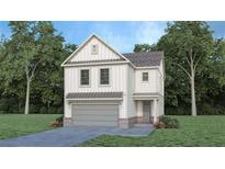 Charming two-story home featuring a modern farmhouse design with a gray garage door and well-manicured lawn at 6128 Knickerbocker St, Mableton, GA 30126