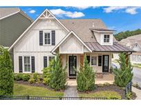 Charming two-story home with board and batten siding, black shutters, and craftsman-style details at 1993 Haley Walk, Atlanta, GA 30318