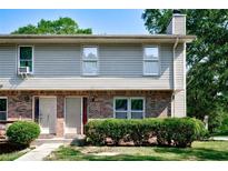 Charming two-story townhouse featuring brick and siding exterior with well-maintained landscaping at 1215 Willow Creek Nw Ct, Conyers, GA 30012