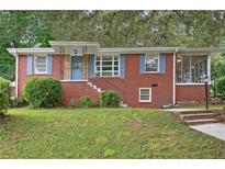 Charming brick home with blue shutters and a well-maintained lawn at 1606 Van Epps Se St, Atlanta, GA 30316