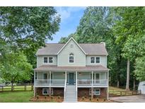 Charming two-story home with a welcoming front porch and well-maintained landscaping at 2060 Candlewood Ne Ct, Marietta, GA 30066
