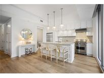 Bright kitchen features stainless steel appliances, marble counters, and counter seating at 1820 Peachtree Nw St # 303, Atlanta, GA 30309
