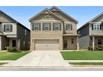 Charming two-story brick home with a well-manicured lawn and two-car garage, perfect for suburban living at 11684 Stovall Place Pl, Hampton, GA 30228