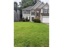 Charming two-story home with neutral siding, stone accents, and an attached two car garage at 3015 Cranbrook Nw Walk, Kennesaw, GA 30144