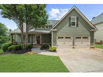 Charming two-story home featuring a two-car garage, covered front porch, and beautifully landscaped front yard at 307 Cabinwood Trl, Canton, GA 30115