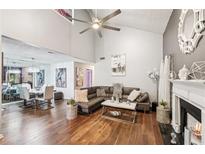 Open-concept living room with hardwood floors, fireplace, and vaulted ceilings offers a spacious and modern design at 4467 Pineridge Cir, Atlanta, GA 30338