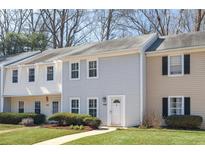 Charming townhouse with light blue siding, white trim, and well-maintained landscaping at 834 Heritage Sq, Decatur, GA 30033