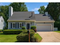 Charming single-story home features manicured landscaping, a neutral color scheme, and an attached two-car garage at 1175 Haven Brook Way, Atlanta, GA 30319
