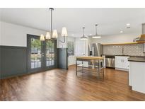 Spacious kitchen and dining area with stainless steel appliances and modern lighting at 355 Winding River Dr # B, Atlanta, GA 30350