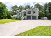 Charming two-story home features a spacious driveway and attached two-car garage at 76 Vaughn Ne Rd, Cartersville, GA 30121