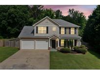Charming two-story home with manicured lawn, two-car garage and beautiful landscaping at 174 Randall Dr, Rockmart, GA 30153
