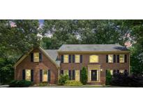 Charming two-story brick home featuring well-manicured landscaping and a welcoming front entrance at 3267 Remembrance Trce, Lawrenceville, GA 30044