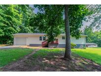 Inviting single-story home featuring a cozy front porch and a well-maintained lawn at 6293 Silver Creek Ln, Austell, GA 30168