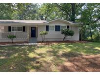 Charming single-story home with a well-maintained front yard, and brick accents at 1026 Eisenhower Se Ct, Atlanta, GA 30354