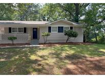 Charming home with a well-maintained front yard and a welcoming entrance at 1026 Eisenhower Se Ct, Atlanta, GA 30354