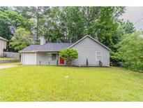 Charming one-story home with well-maintained lawn and a red front door adding a pop of color at 4164 Little Nw Spgs, Kennesaw, GA 30144
