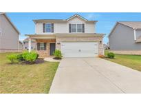 Charming two-story home with stone accents, a two-car garage, and a well-maintained front yard at 513 Moline Way, Locust Grove, GA 30248