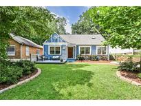 Charming blue home with inviting front porch and lush, well-manicured lawn at 1136 Moreland Se Pl, Atlanta, GA 30316