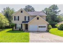 Charming two-story home with a well-maintained front yard and attached two-car garage at 9542 Canvasback Ct, Jonesboro, GA 30238